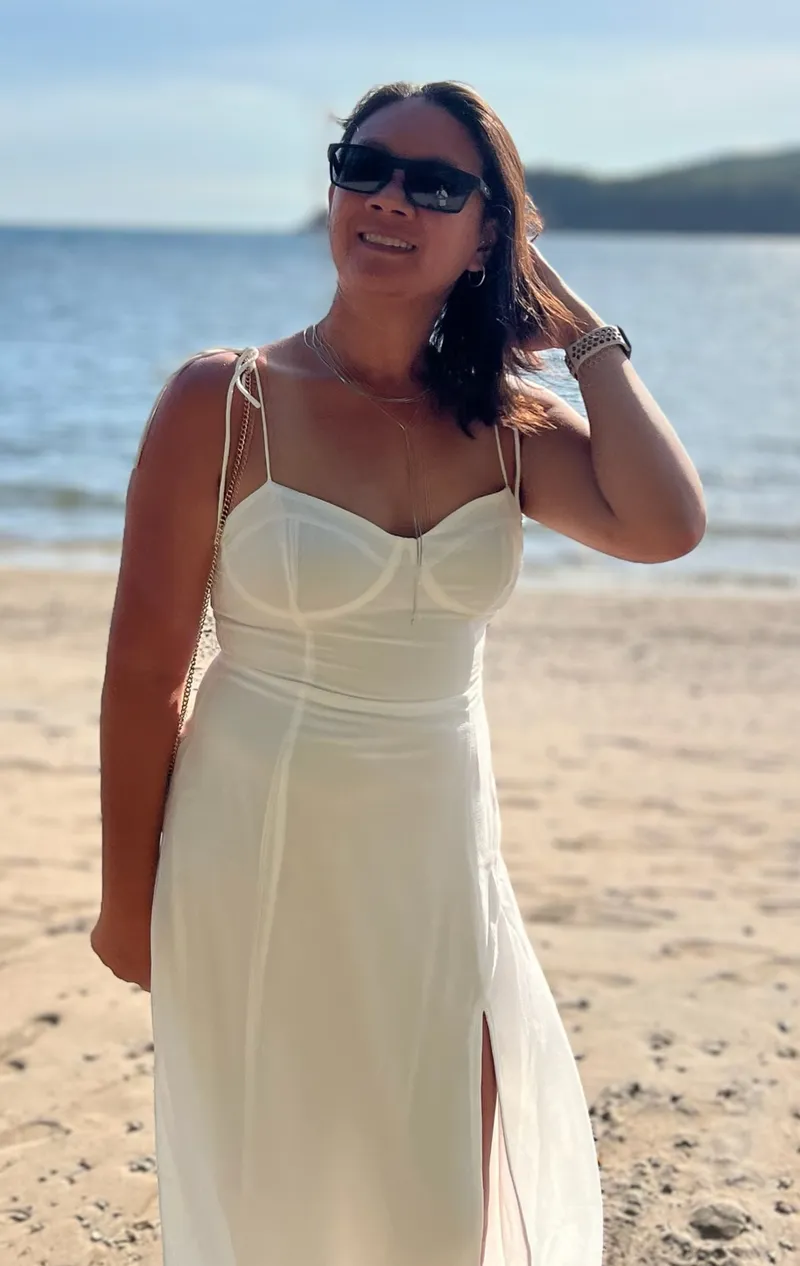 Nicole Chen on a beach, smiling