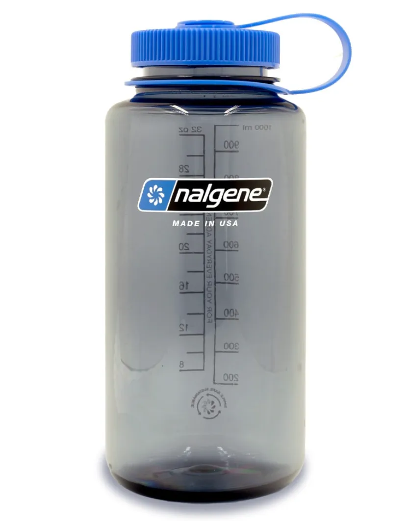 Nalgene Wide Mouth 32oz water bottle in smoke gray with blue lid, featuring measurement markings and durable BPA-free plastic, made in the USA.